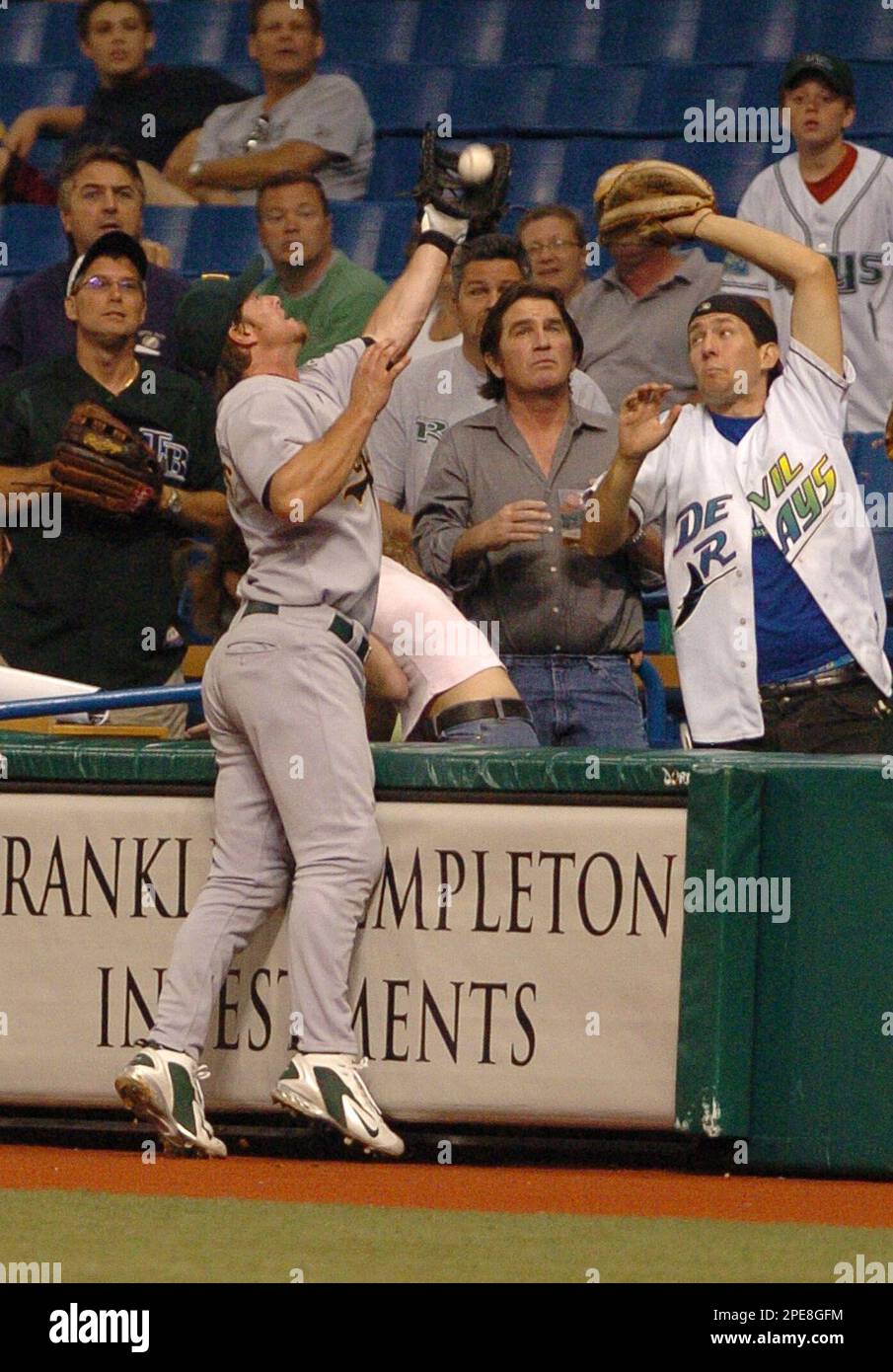 Oakland Athletics first baseman Scott Hatteberg catches a pop fly hit by  Tampa Bay Devil Rays' Julio Lugo in the first row for the final out of the  second inning Saturday, April