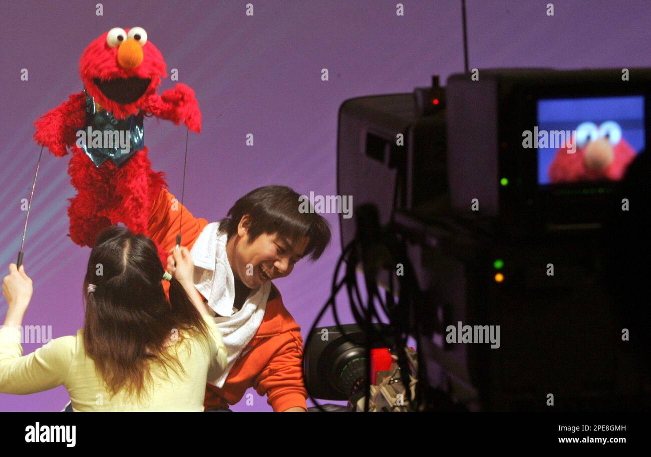 Muppet Camera Operator Kenta Matsumoto, a Muppet operator, handles Elmo, a popular Sesame ...