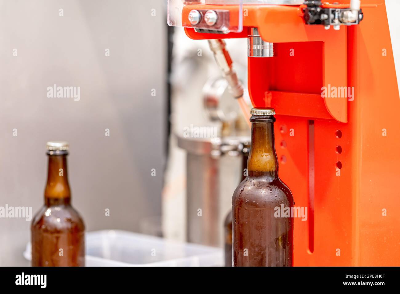 capping beer bottles in a brewery Stock Photo