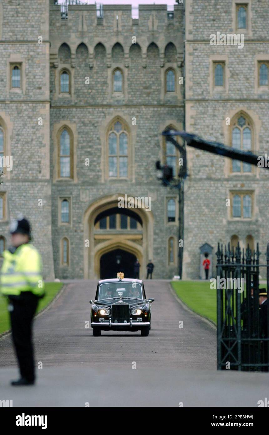 A car carrying Prince Charles and Camilla Parker Bowles leaves