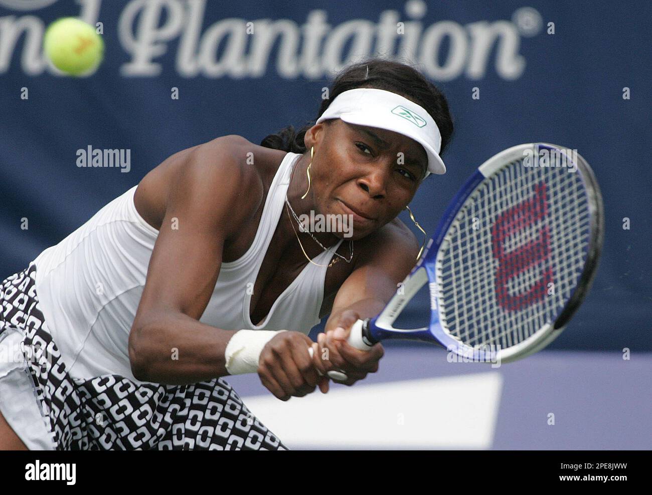 Venus Williams returns a shot to Lindsay Davenport during their match