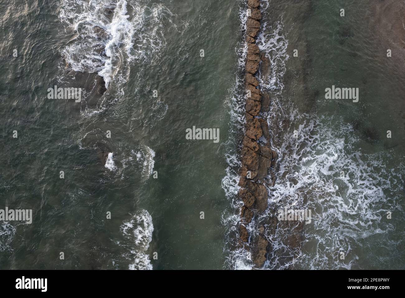 Waves hit rock stone above top view. Texture of shallow sea Stock Photo