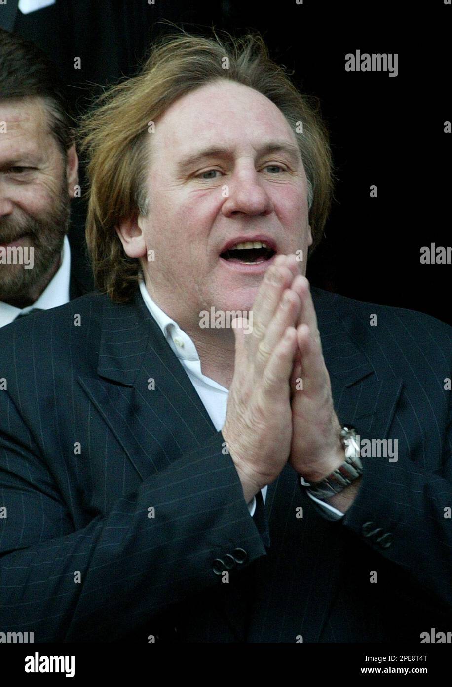 French actor Gerard Depardieu gestures during his arrival for the