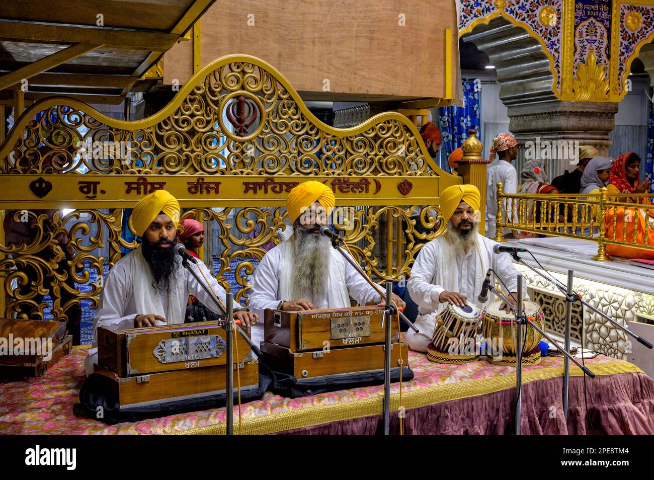 Three Sikh men with turbans and beards play music during a service at the Gurdwara Sis Ganj Sahib Sikh temple in Chandni Chowk,Old Delhi Stock Photo