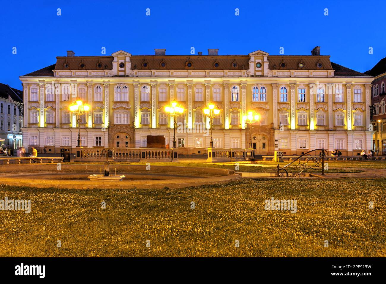 Baroque Palace (Palatul Baroc) in Piata Unirii (Union Square), Timisoara, Romania at night. Currently housing the National Museum of Art, it dates to Stock Photo