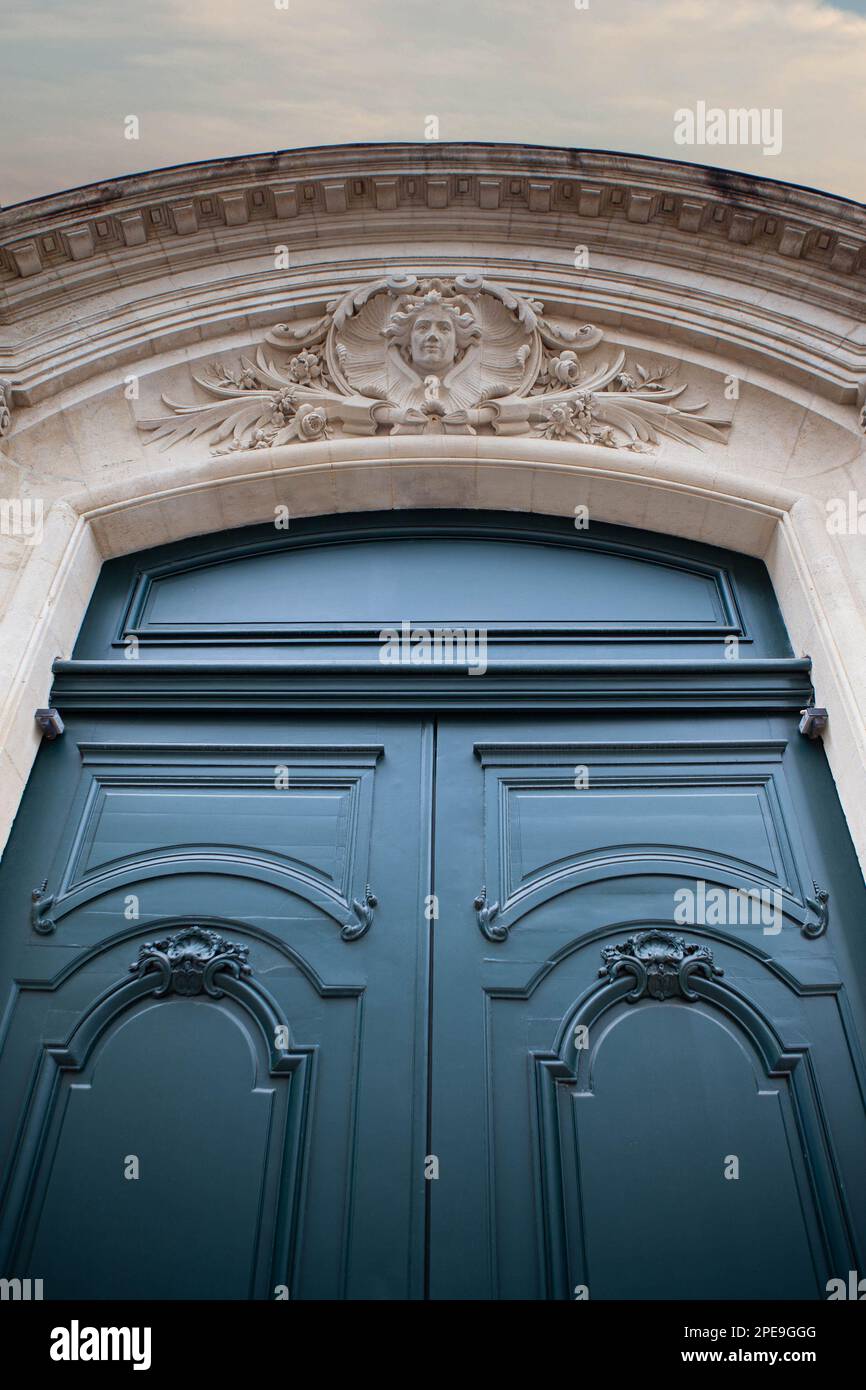 Monumental blue wooden door and stone facade Stock Photo - Alamy