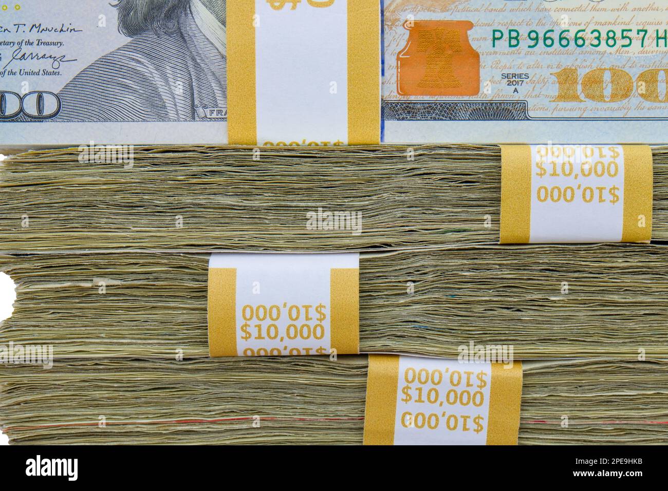 Close up side view of 4 straps of ten thousand, one hundred US dollar bills stacked on top of each other Stock Photo