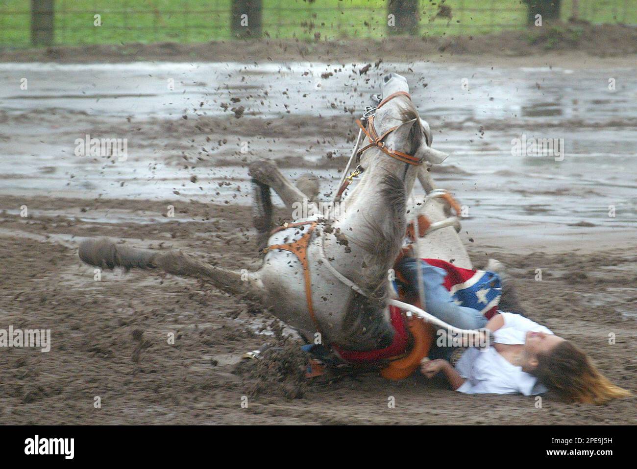 Marsha Williamson and her horse take a spill while barrel racing during  Cracker Day Saturday, March 26, 2005, at the Flagler County Fair Grounds in  Flagler Beach, Fla. Neither rider nor horse