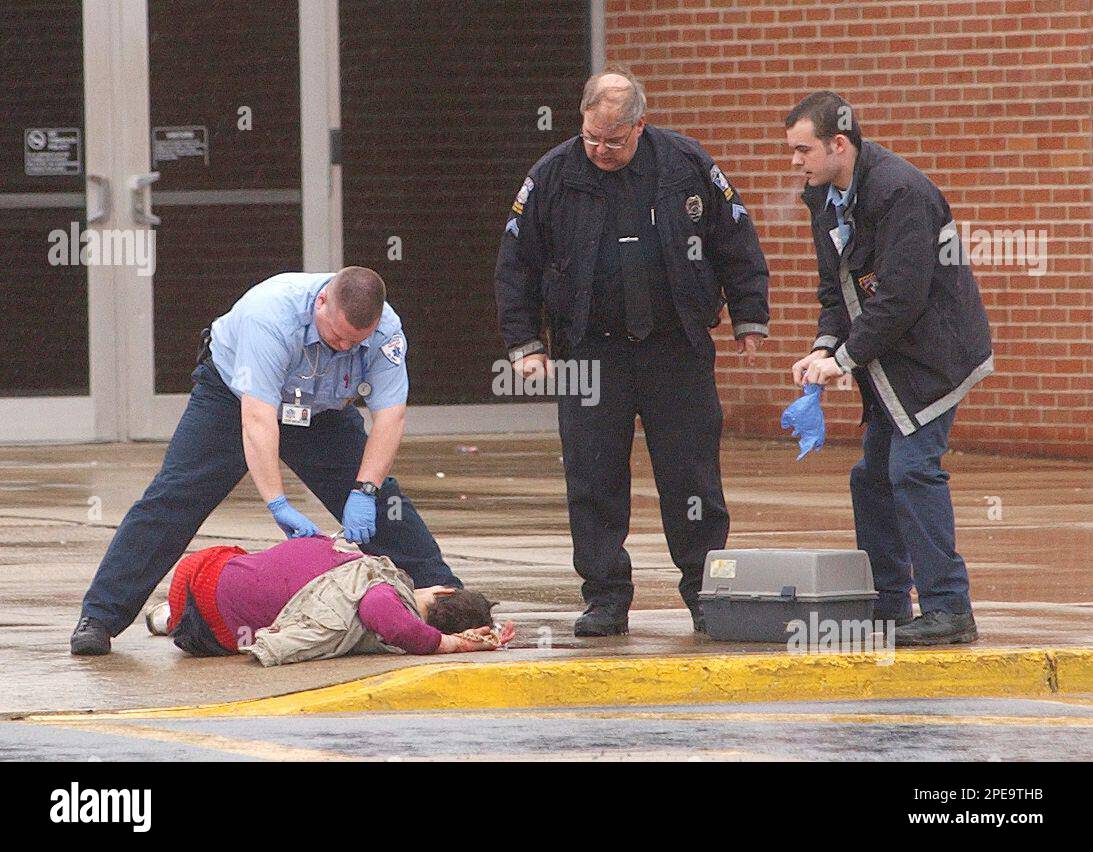 Paramedics aide a shooting victim outside the Indiana Area Senior High
