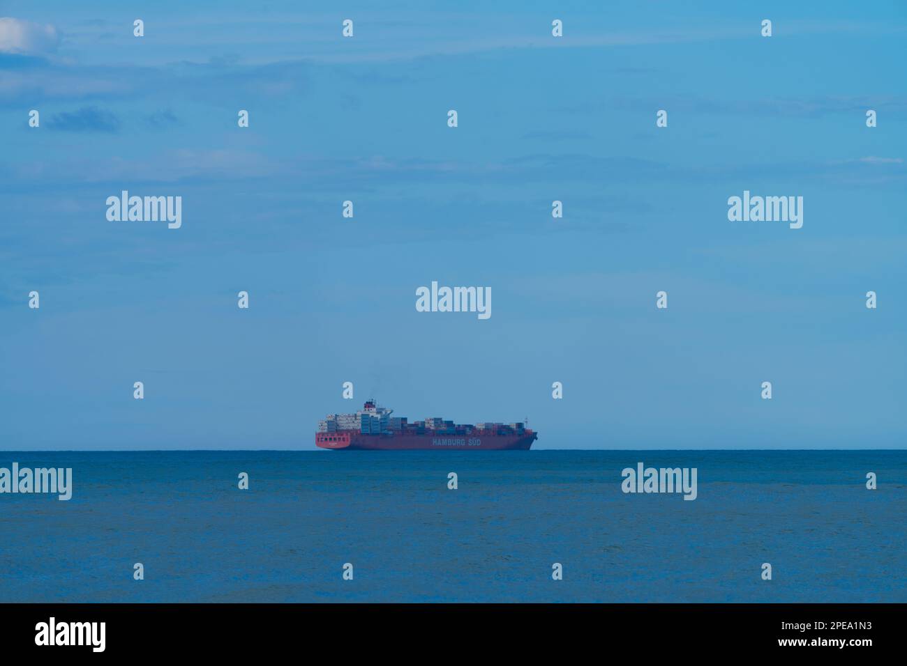 Container ship at sea side view in ocean outside Christchurch, New Zealand. Stock Photo