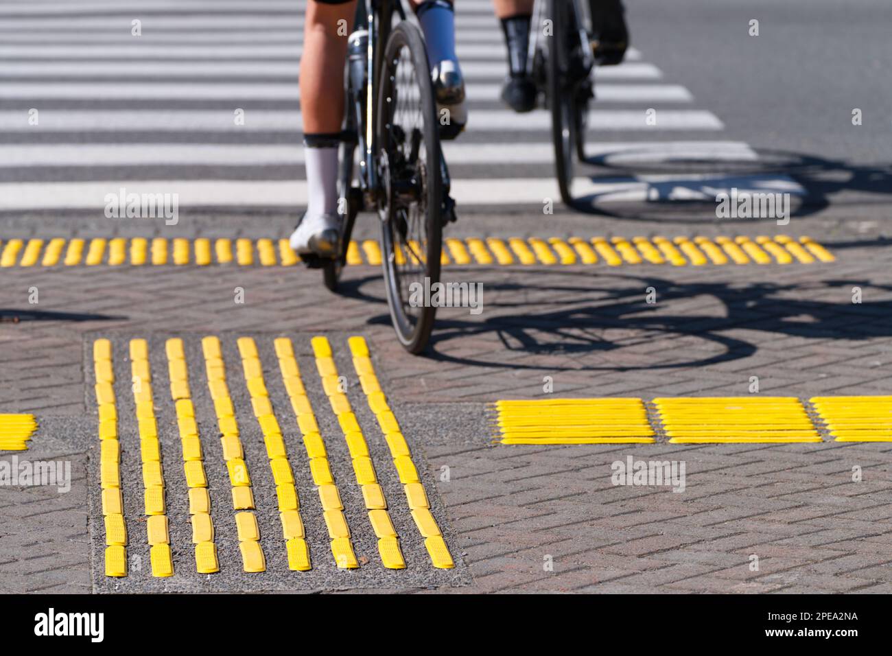 Cyclists crossing road using a pedestrian crossing in Lyttelton