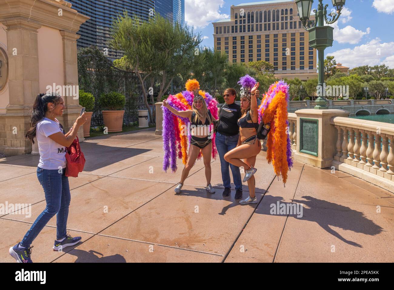 Tourists taking pictures with entertainment girls on Strip Las Vegas, Nevada, USA. Stock Photo