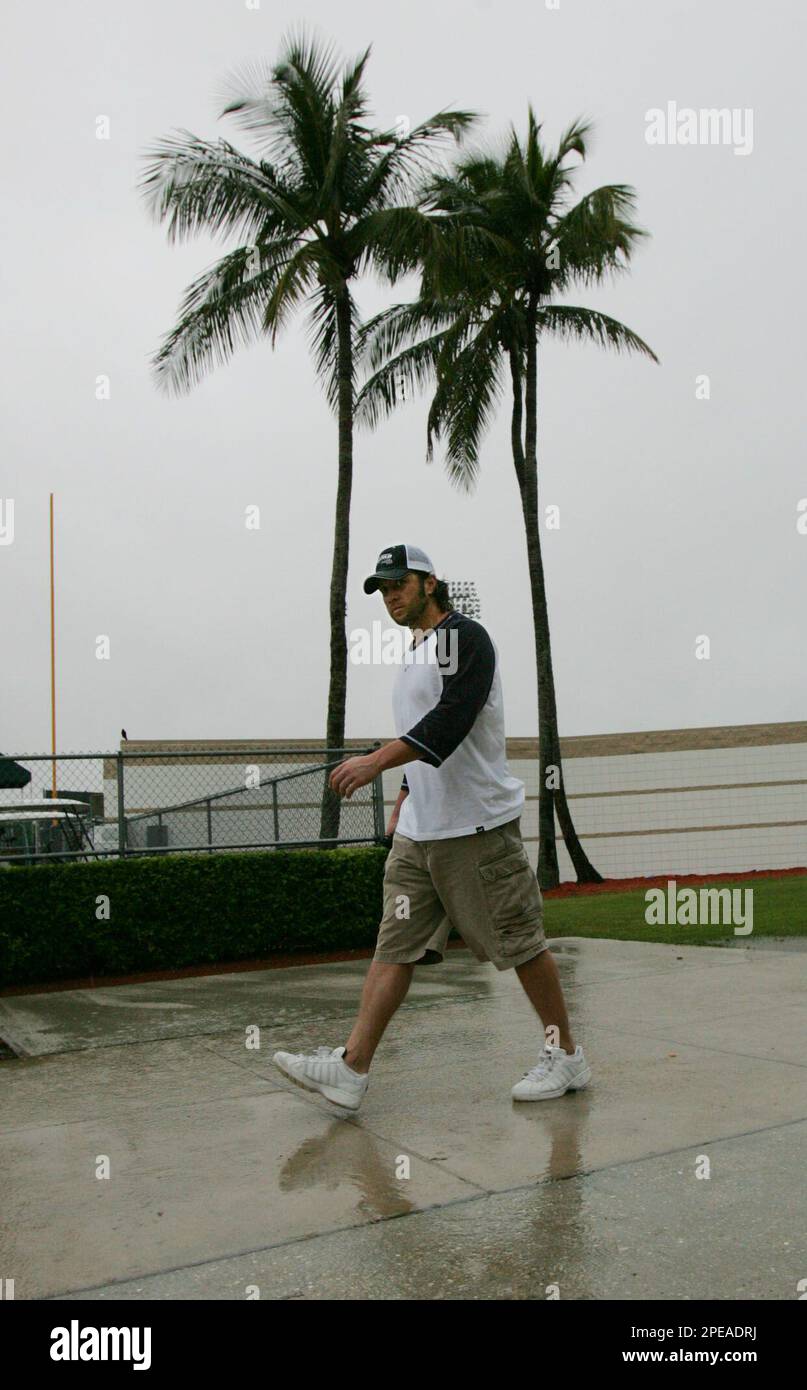 Boston Red Sox second baseman Mark Bellhorn walks in the rain past