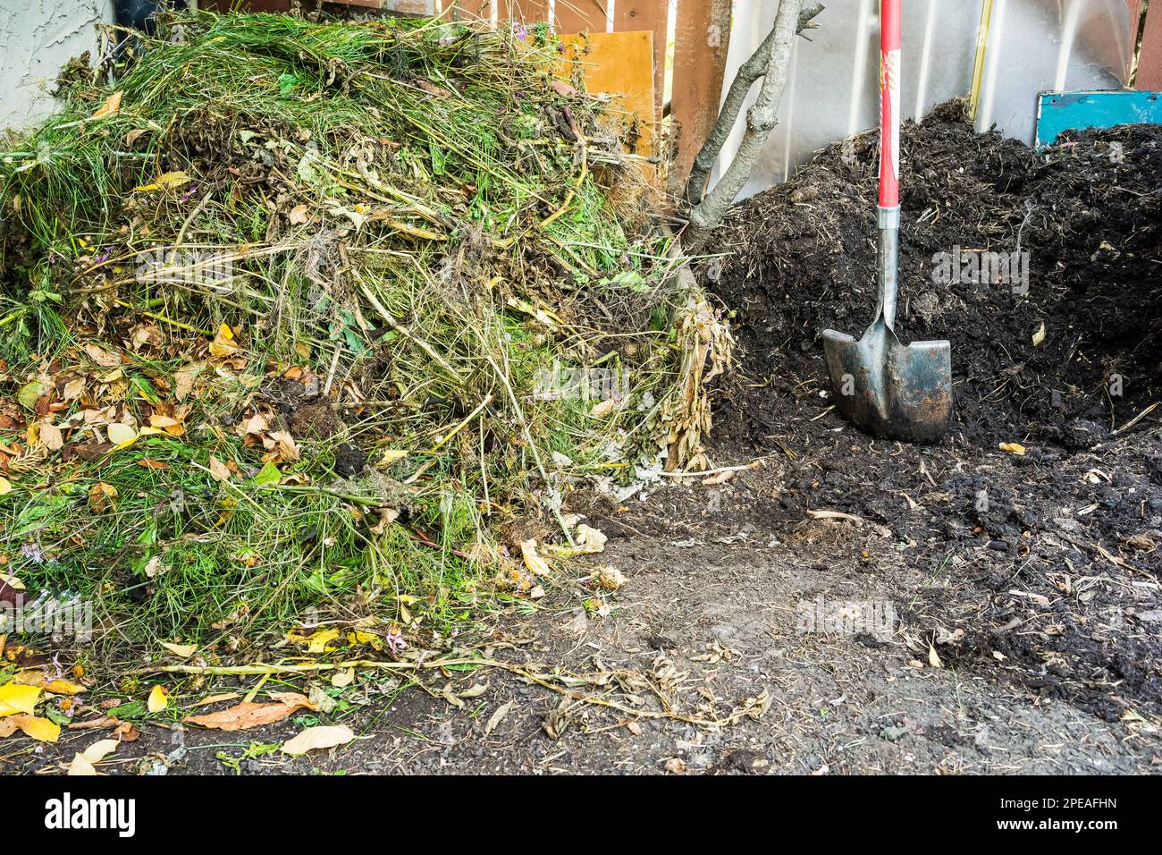 Two composting piles in garden side by side ready to use and fresh