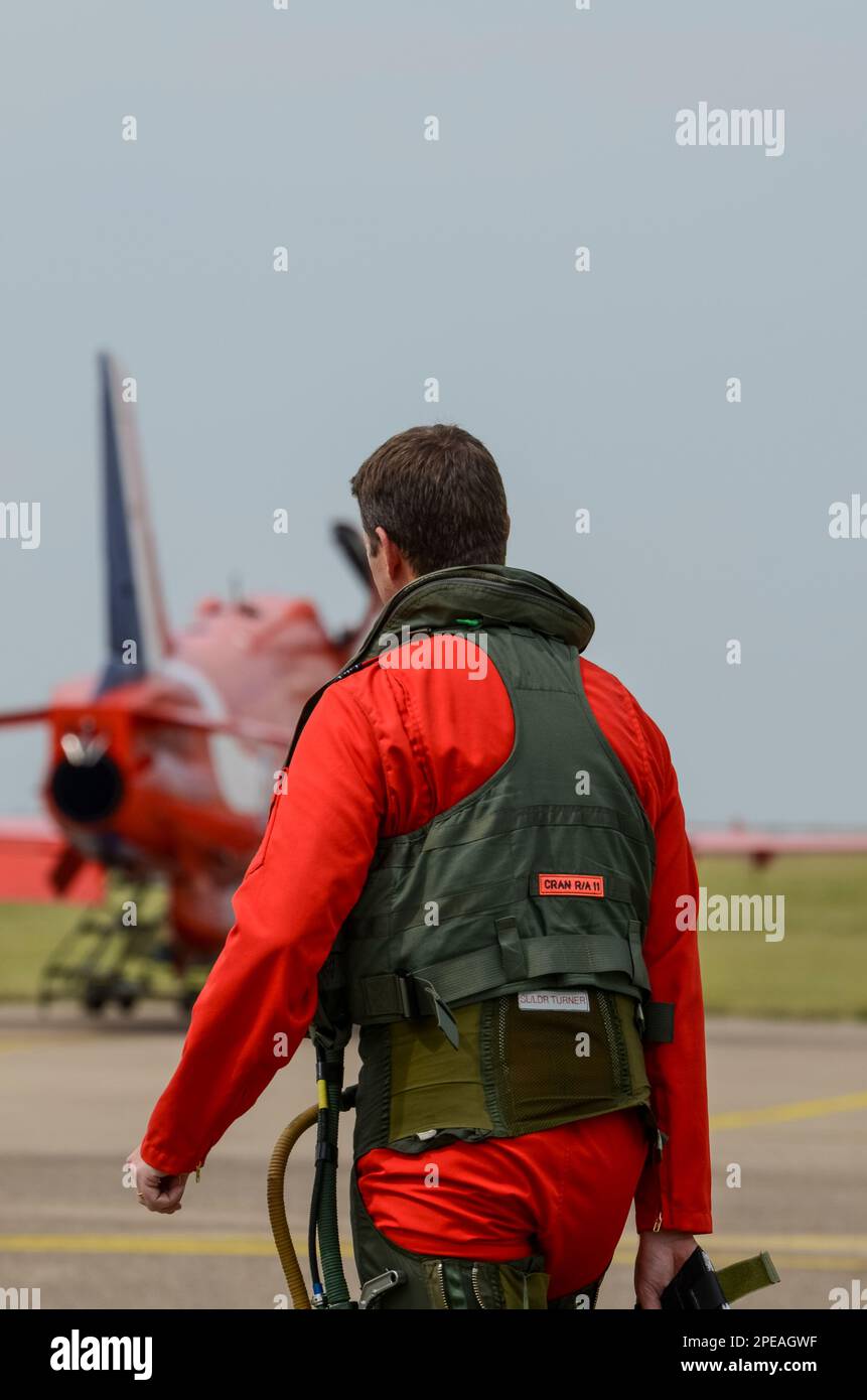 Royal Air Force Red Arrows display team pilot Sqn Ldr Jim Turner walking out to BAe Hawk T1 jet plane prior to display at RAF Scampton. G suit, vest Stock Photo