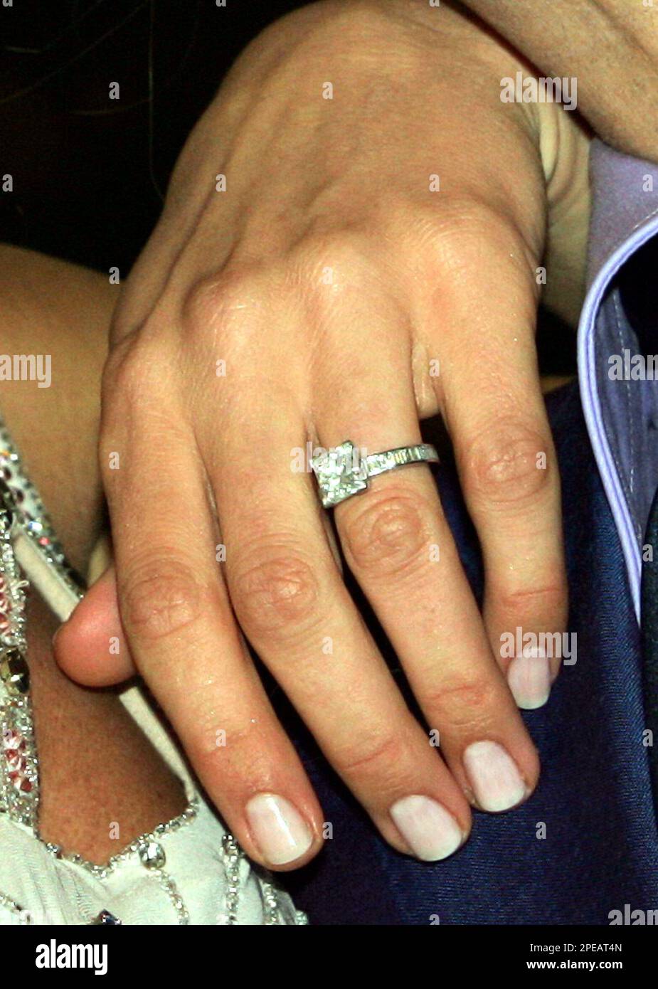 penny lancaster shows her princess cut diamond engagement ring after the announcement that she will marry rock star rod stewart in central london saturday march 12 2005 the couple are expected to marry in a church service somewhere in europe later in 2005 ap photomartin cleaver 2PEAT4N