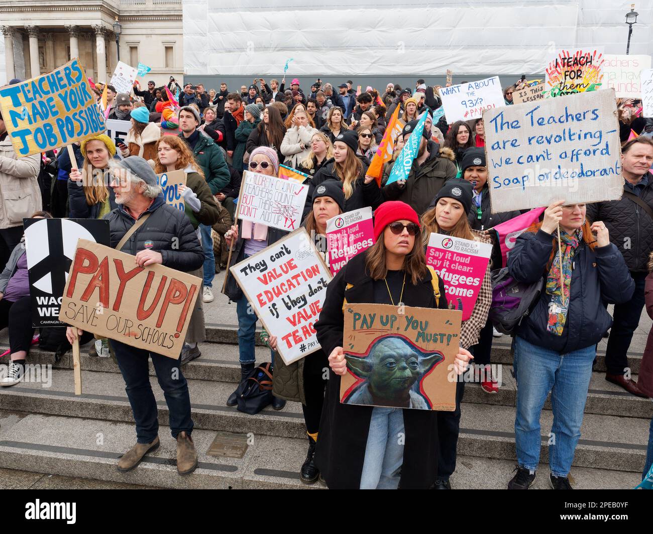 Striking teachers waving banners and protesting at a rally in Trafalgar Square London on Budget Day 15 March 2023 Stock Photo