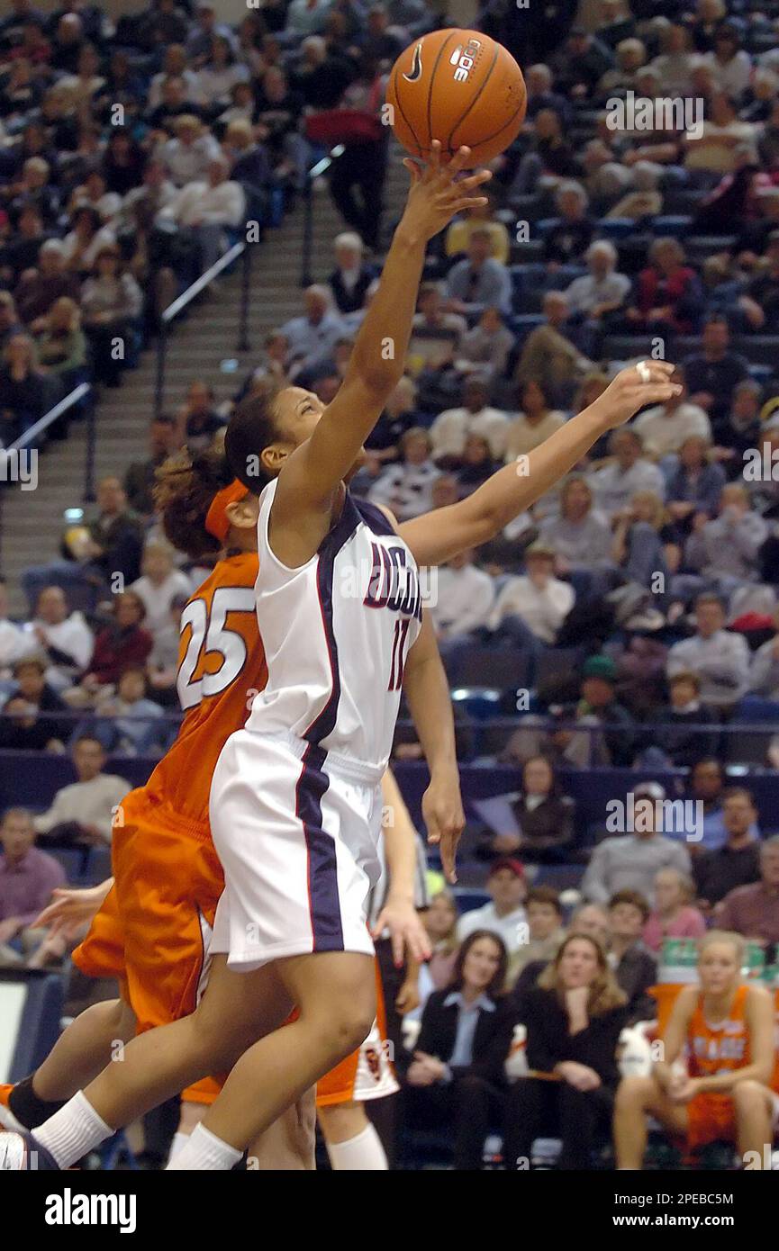 Connecticut's Ketia Swanier comes in for a shot guarded by Syracuse's Tracy Harbut in the first half of the quarterfinal game in the Big East Championship in Hartford, Conn., Sunday, March 6, 2005. (AP Photo/Bob Child) Stock Photo
