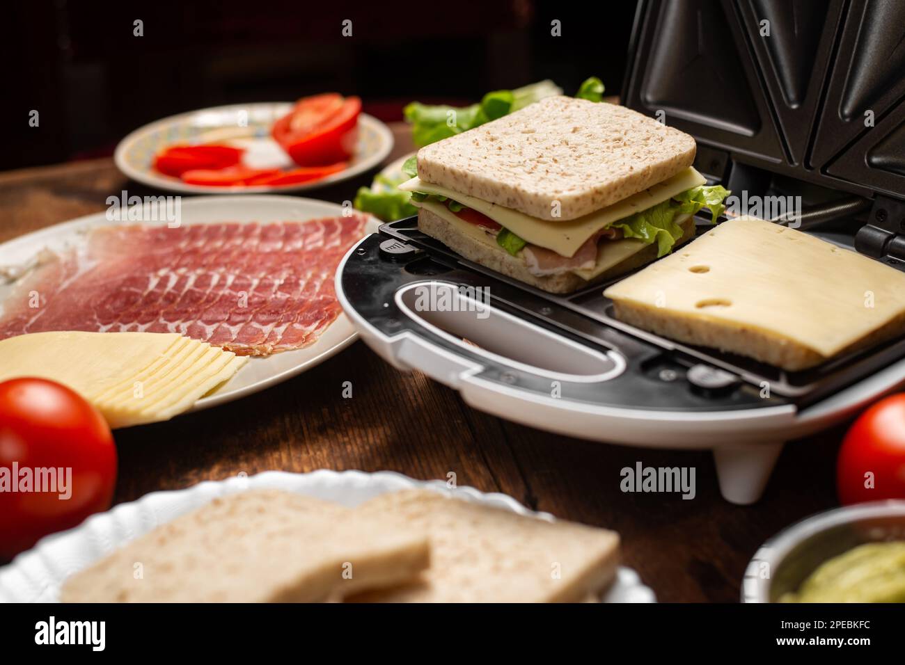 Cooking sandwiches with different fillings. Sandwich maker and various