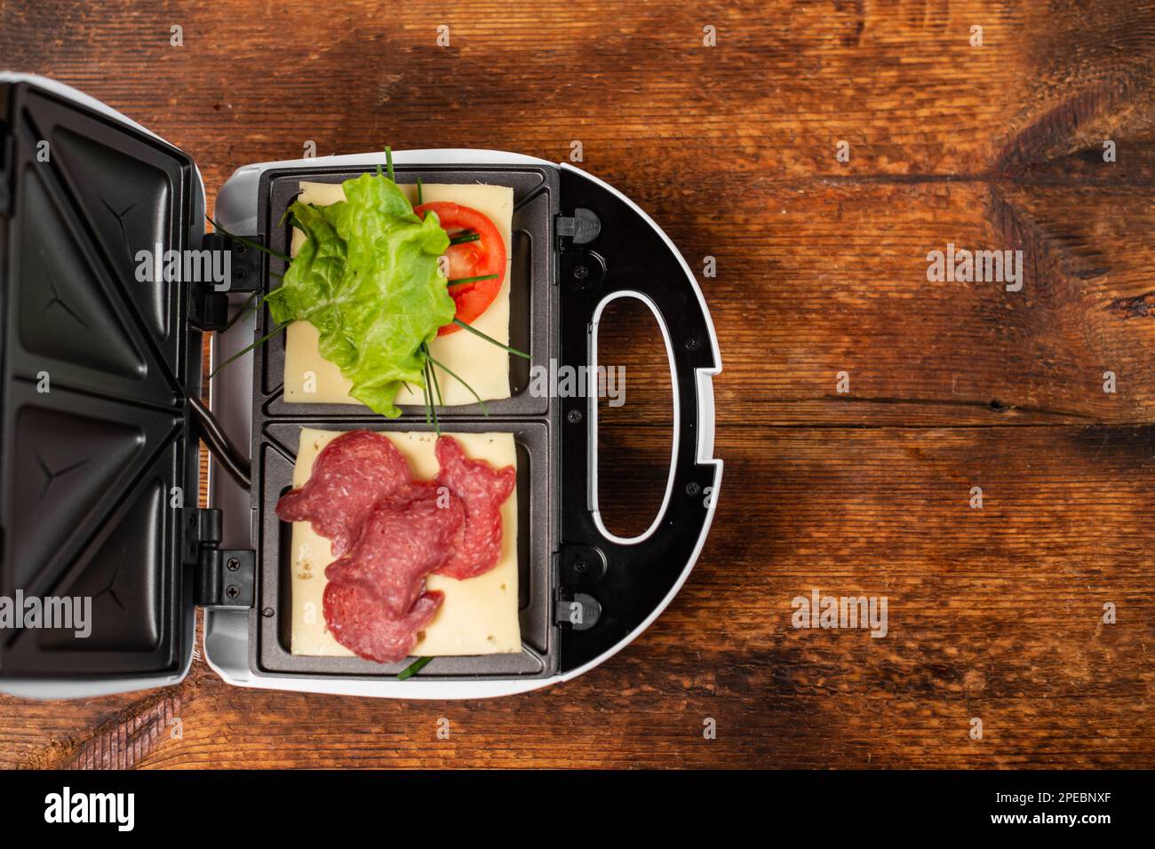 Vegetarian and meat sandwich in a sandwich maker. Different types of