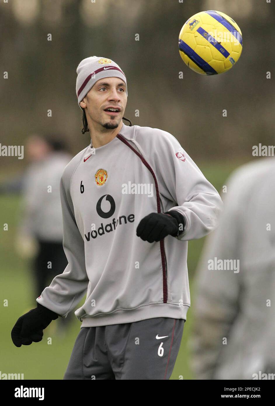 Manchester United defender Rio Ferdinand keeps his eye on the ball as his  team are put through their paces at their Carrington training ground in  Manchester, England, Tuesday, Feb. 22, 2005, the, image size:942x1390