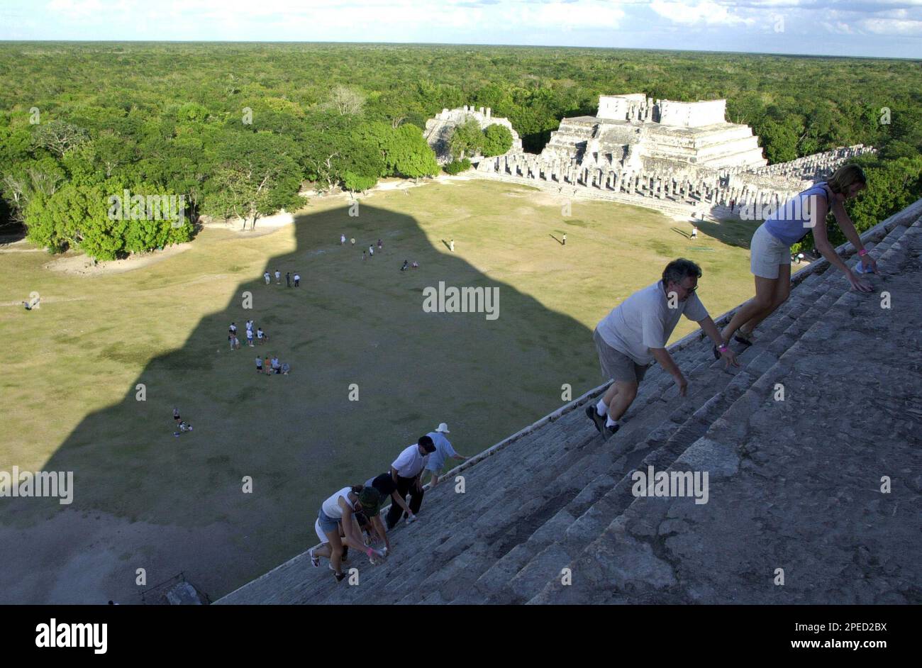 Tourists climb the ruins of Chichen Itza in the Yucatan Penninsula