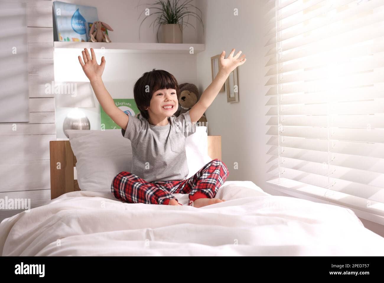 Happy little boy on bed at home Stock Photo - Alamy