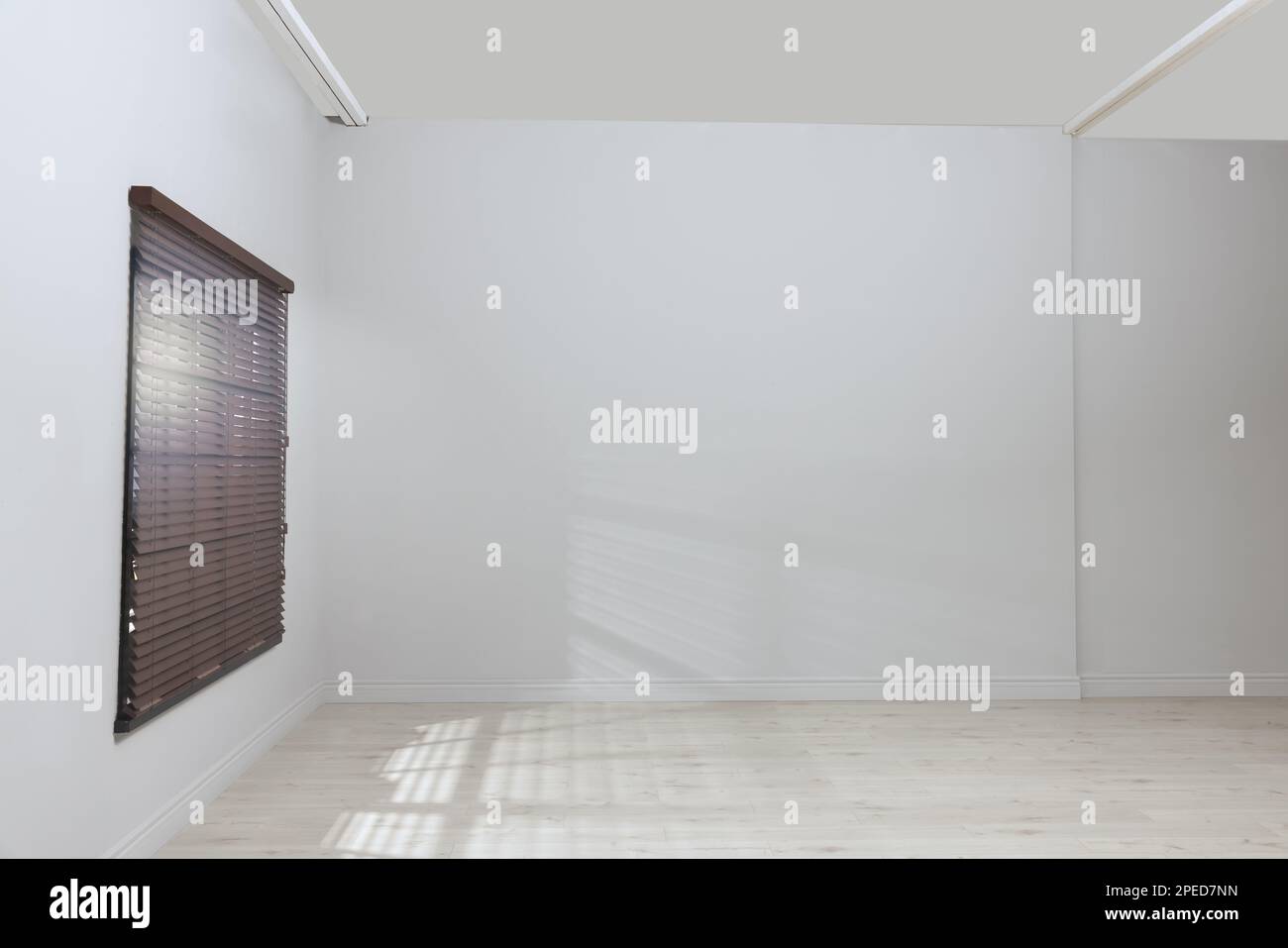Empty room with white walls, large window and wooden floor Stock Photo