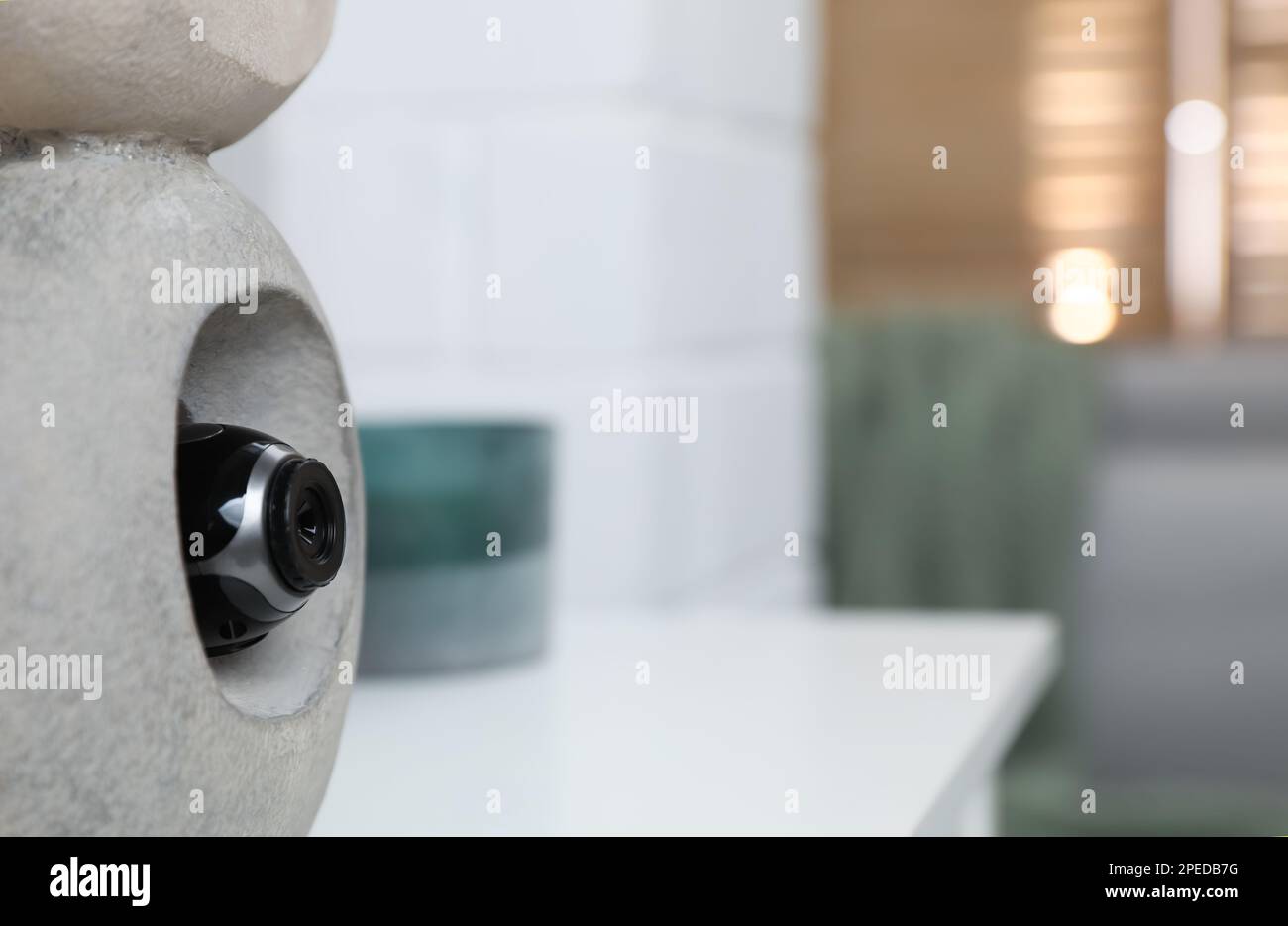 Statue with small hidden camera in room Stock Photo