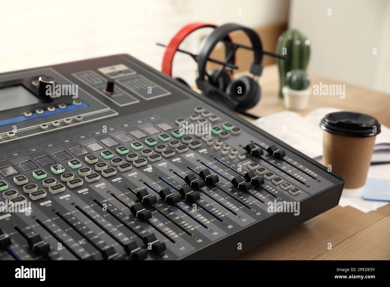 Professional mixing console on wooden table in modern radio studio ...