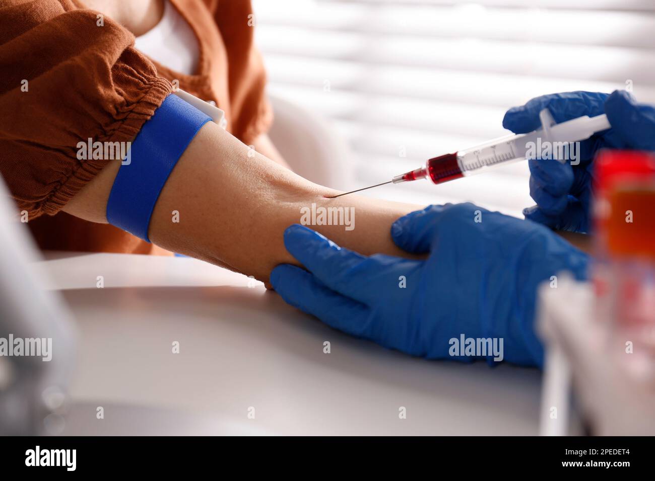Nurse drawing blood sample from patient in clinic, closeup Stock Photo