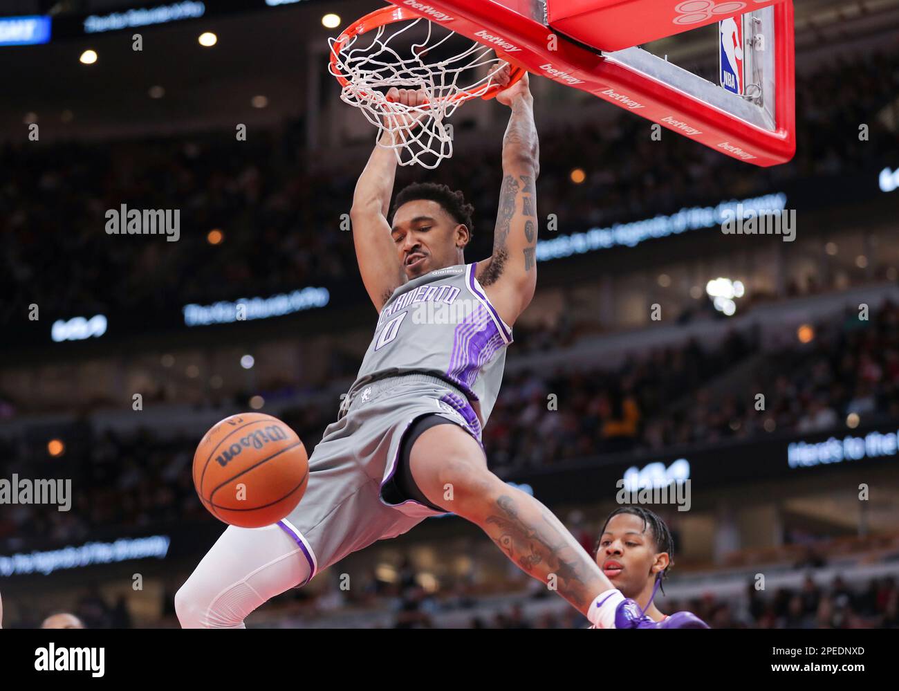 CHICAGO, IL - MARCH 15: Sacramento Kings guard Malik Monk (0) slam dunks  during a NBA game between the Sacramento Kings and the Chicago Bulls on  March 15, 2023 at the United