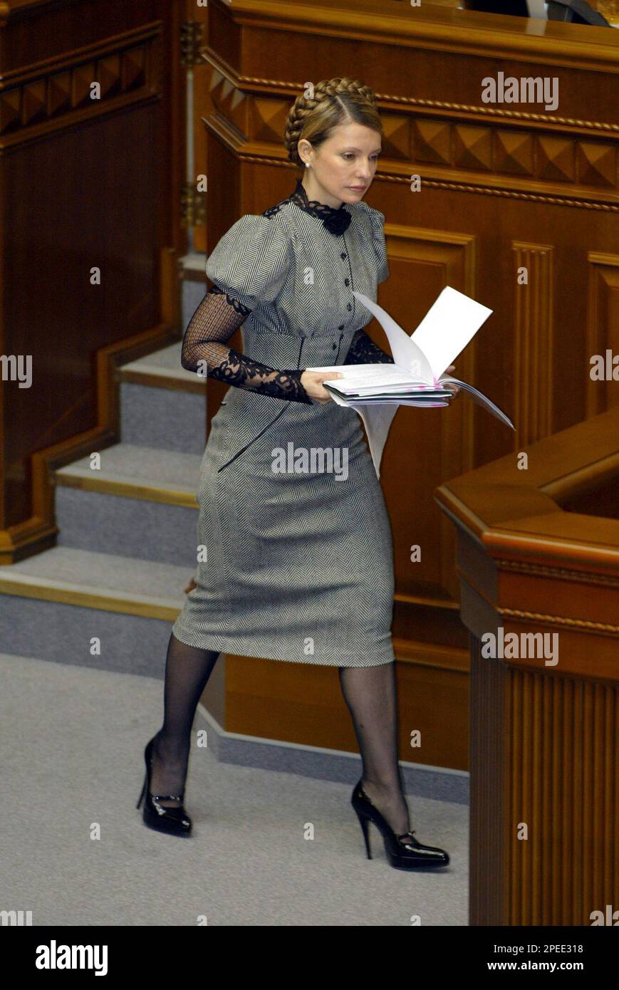 Acting Ukrainian Prime Minister Yulia Tymoshenko prepeares to read a programm of a new government in the Ukrainian parliament in Kiev, Friday, Feb. 4, 2005 . Tymoshenko's nomination for Ukraine's No. 2 job topped the agenda Friday as parliament reconvened, while behind-the-scenes dealmaking persisted for other influential posts in President Viktor Yushchenko's new government. ( AP Photo/ Sergei Grits) Stock Photo