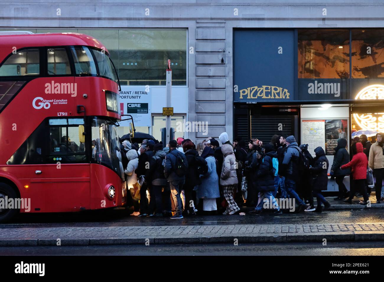 London, UK. 15th March, 2023. Passengers queue for a bus in the Strand during rush hour. A 24-hour strike by members of the Aslef and RMT Unions, closed-down Transport for London's (TfL) underground services, causing a knock-on effect by an increase in road traffic congestion, with also overcrowding on buses and overground trains.   Credit: Eleventh Hour Photography/Alamy Live News Stock Photo