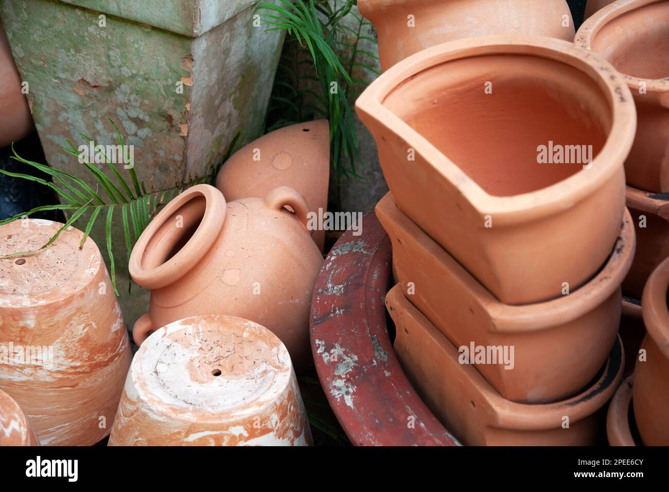 Many assorted ceramic plant pots at the market. A lot of terra cotta clay pots stored outdoors for garden decoration and landscaping Stock Photo