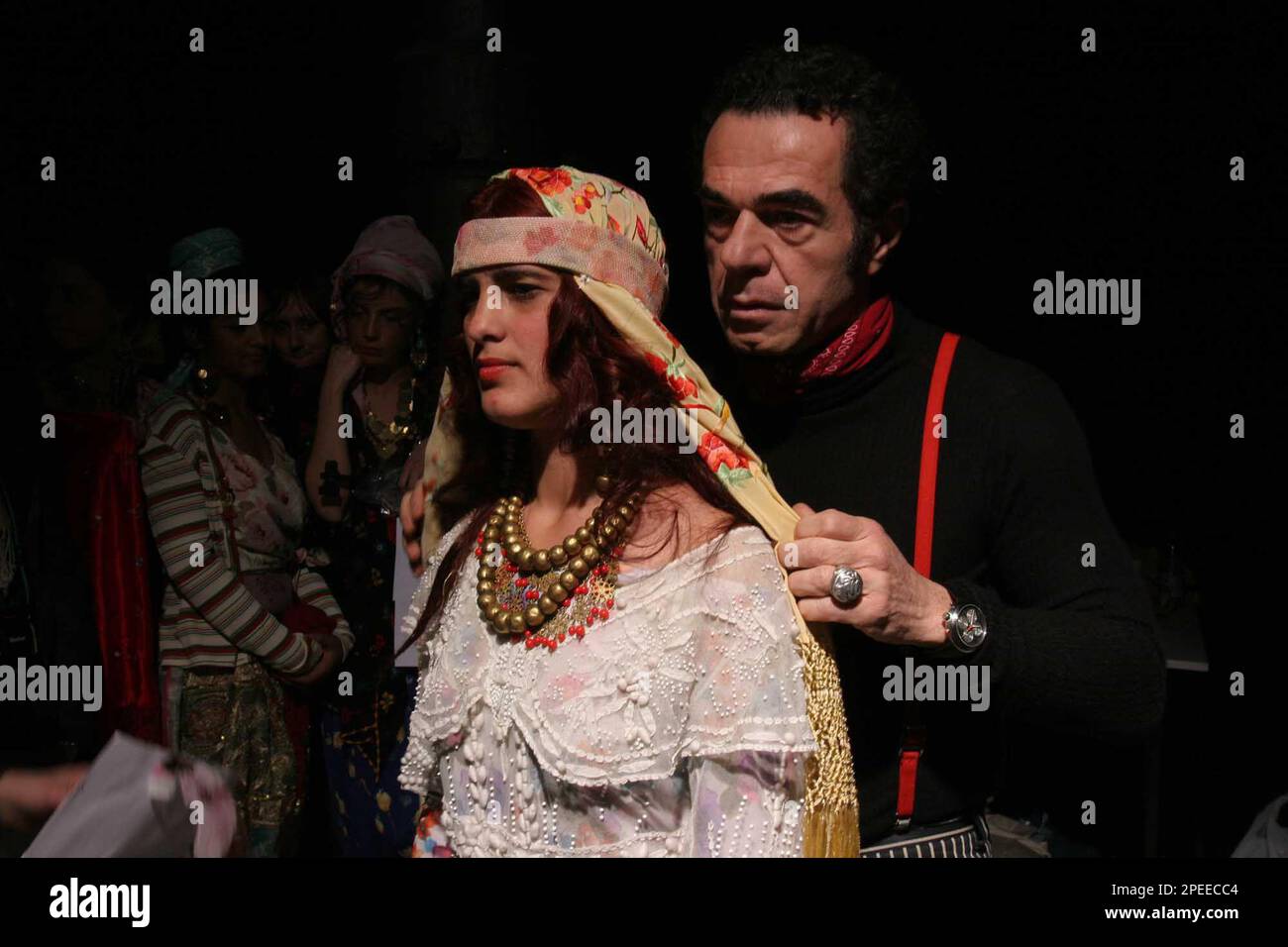 Italian designer Romeo Gigli prepares Claudia from Romania one of