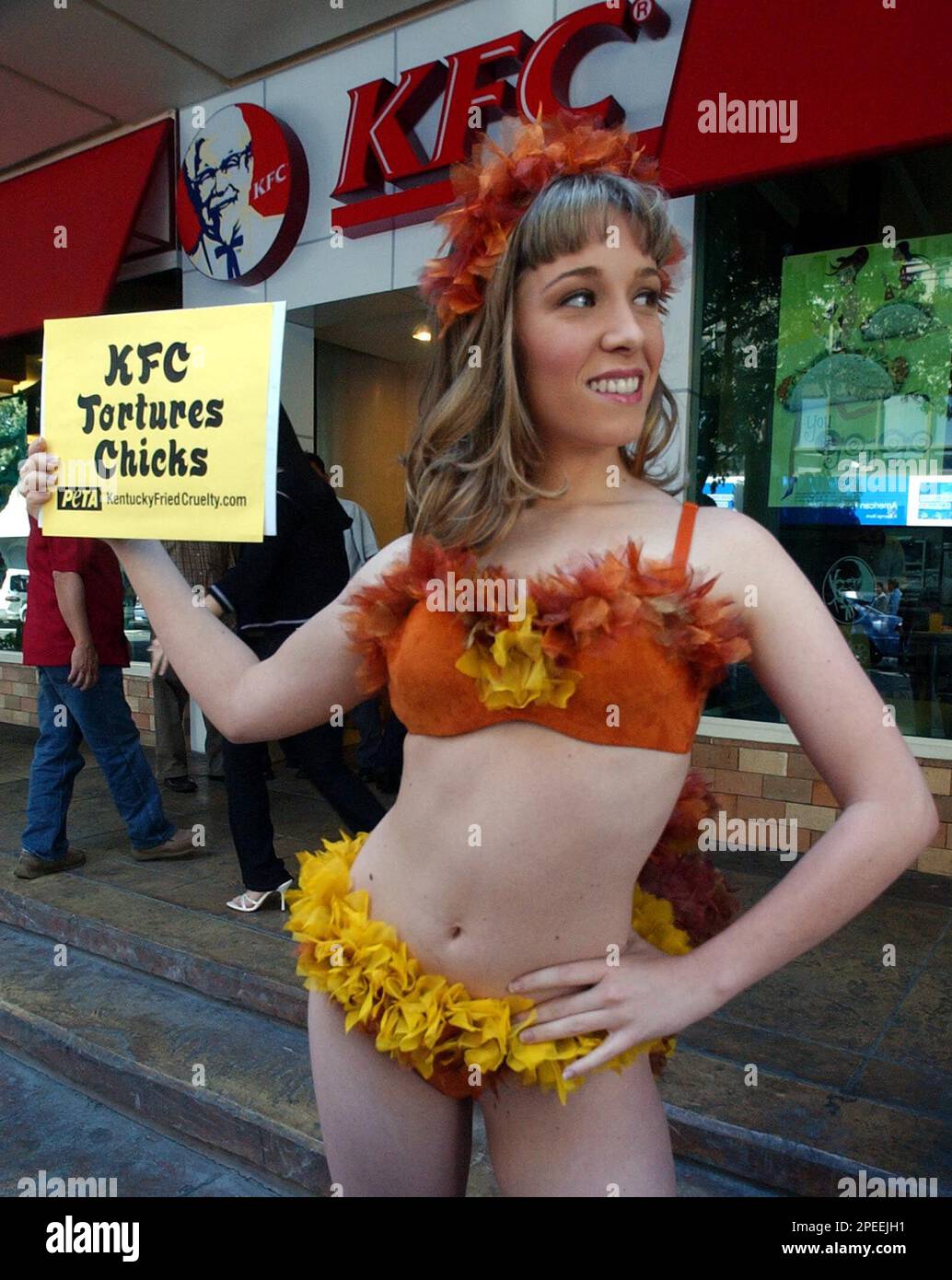 PETA (People for the Ethical Treatment of Animals) activist Allison Ezell  from Louisville, Ky. in costume, pose in front of a Kentucky Fried Chicken  store during their campaign Friday, Jan. 28, 2005