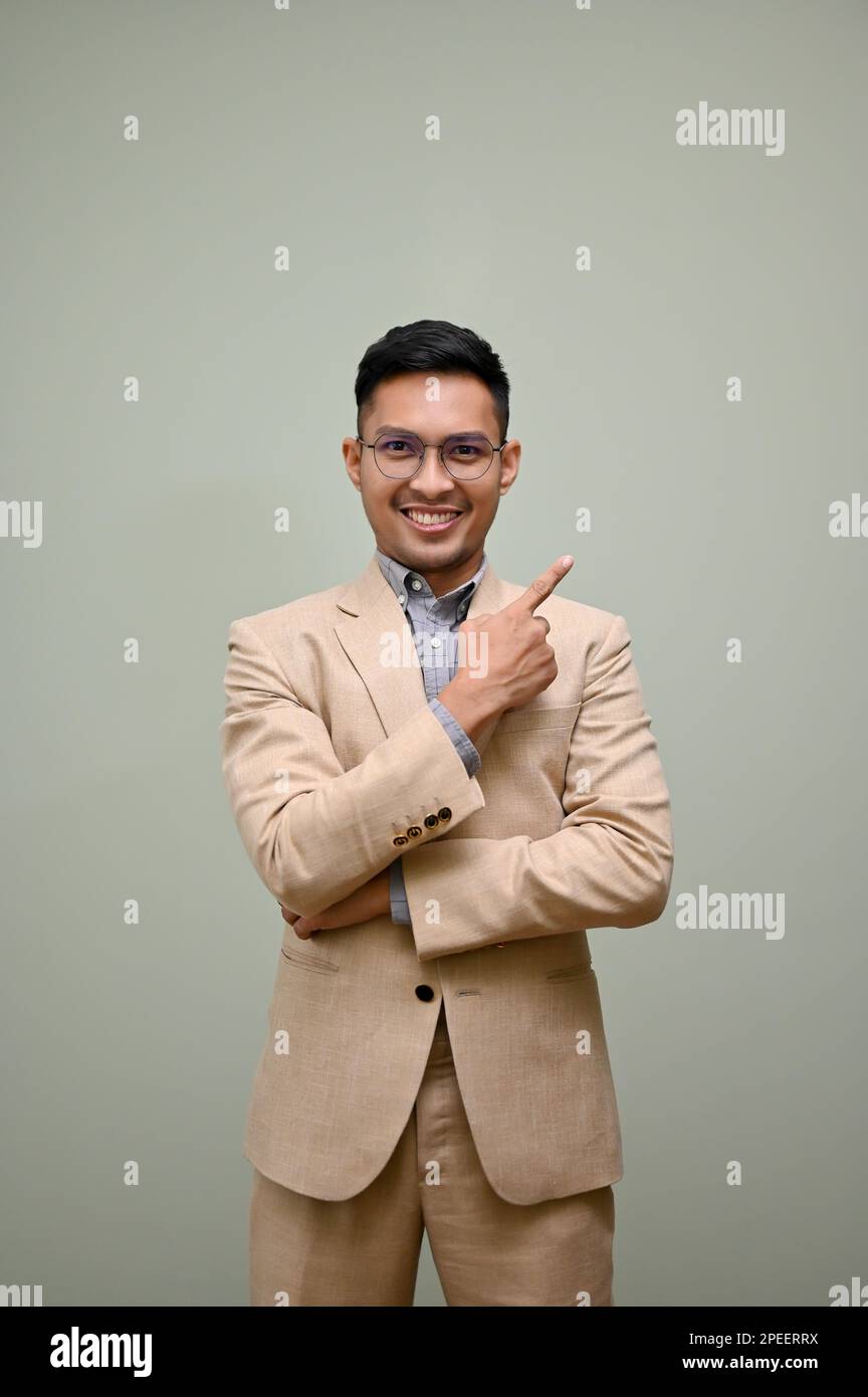 Portrait of smiling handsome millennial Asian businessman in formal