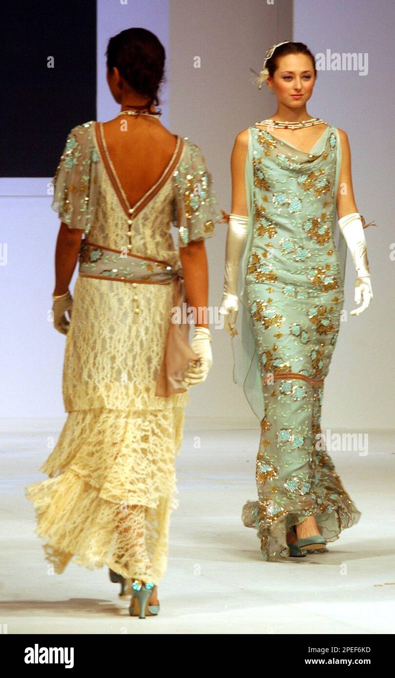 Models display evening gowns by Malaysian fashion designer