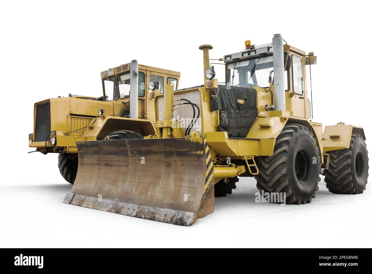 Two yellow heavy wheeled tractors isolated on white background Stock