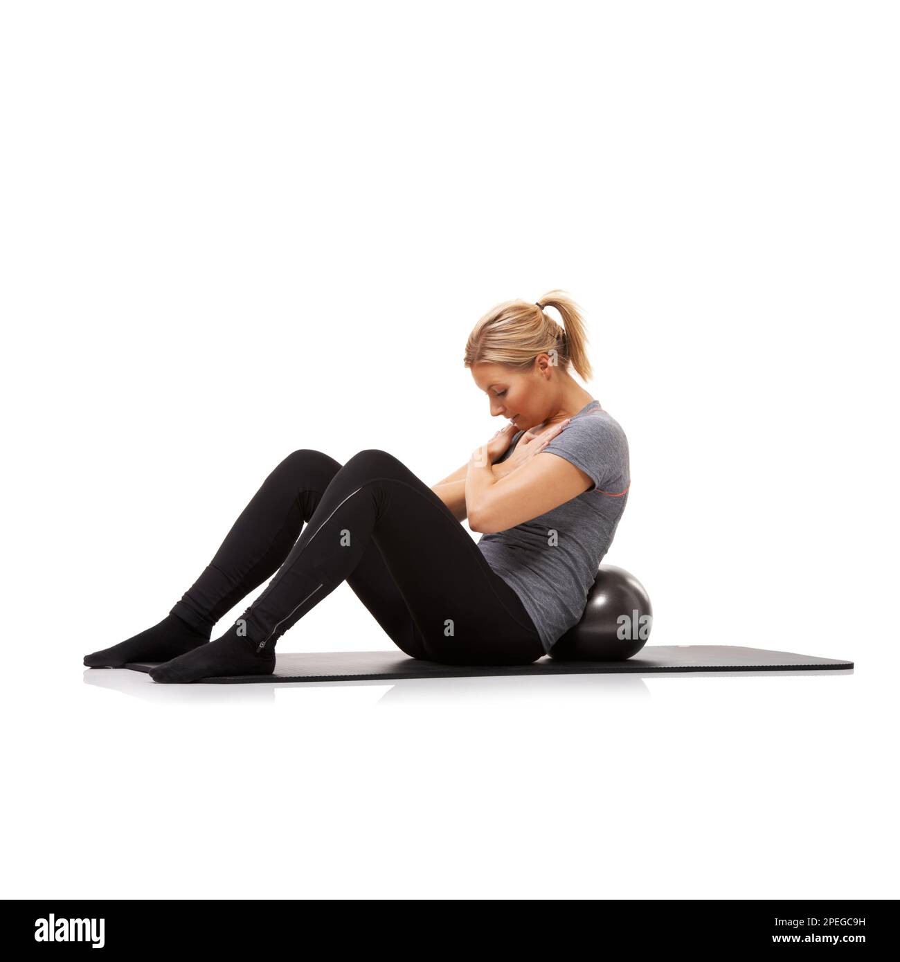 One more... come on. A young woman doing situps on an exercise ball