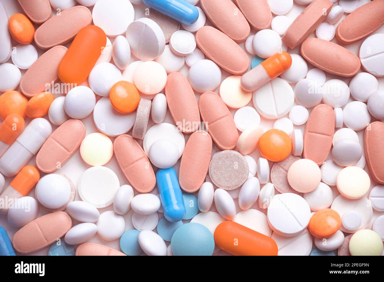 Spilled blue white pink orange pills background Stock Photo