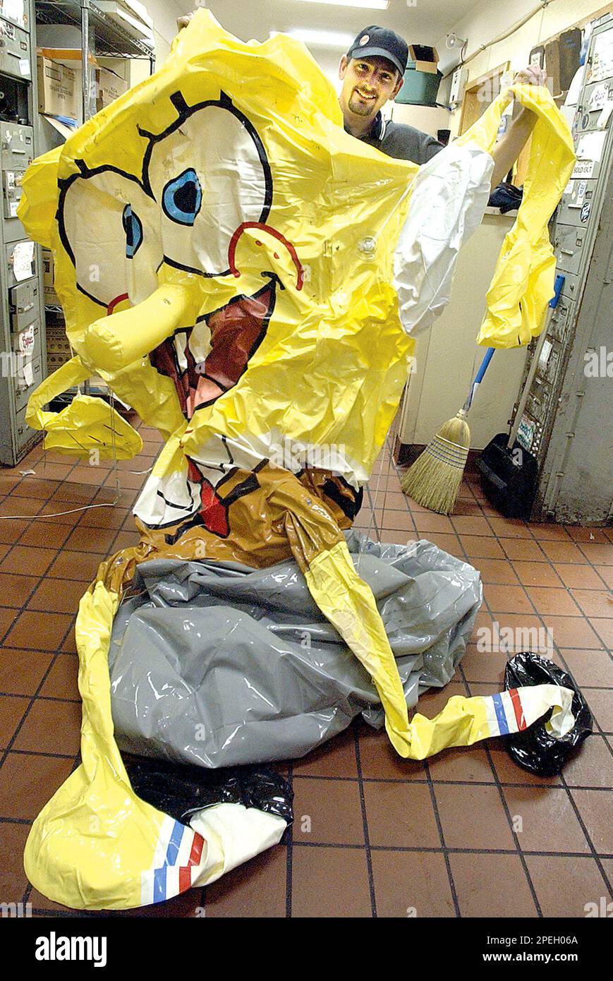 Stanley Colburn, manager of the Main Street Burger King in Lewiston, Maine,  holds a SpongeBob SquarePants inflatable Friday, Dec. 10, 2004, after it  was stolen from the roof of the restaurant Dec.