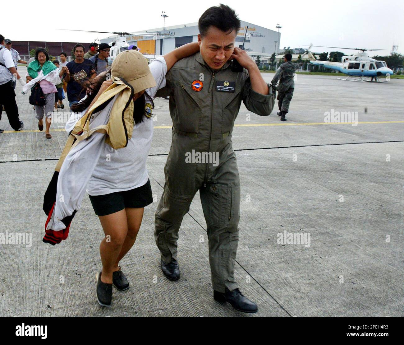 A Philippine Air Force personnel gives an evacuee of typhoon survivors