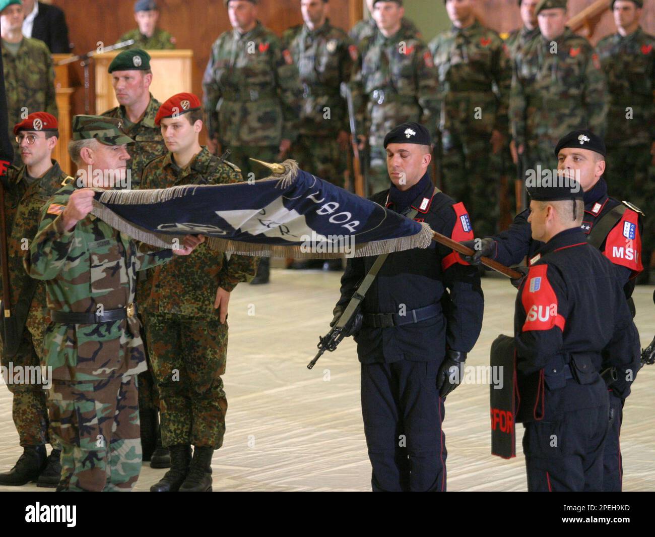 Troops from different countries attend a ceremony of handing over ...