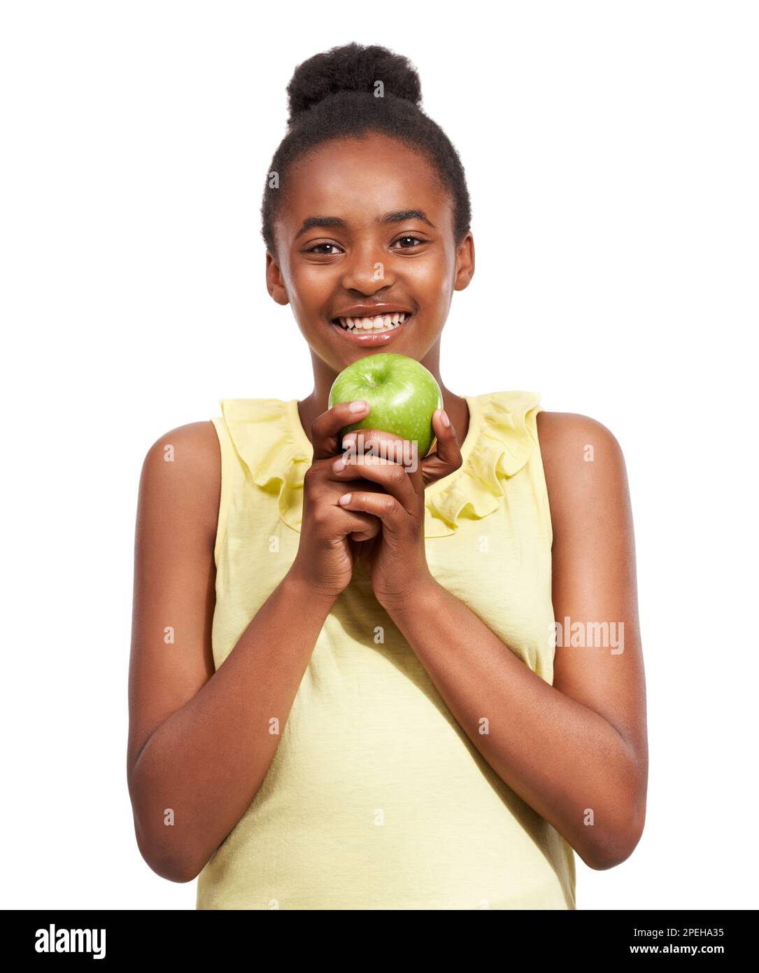 Keeping kids healthy - apples. Studio portrait of a young african american girl holding an apple isolated on white. Stock Photo