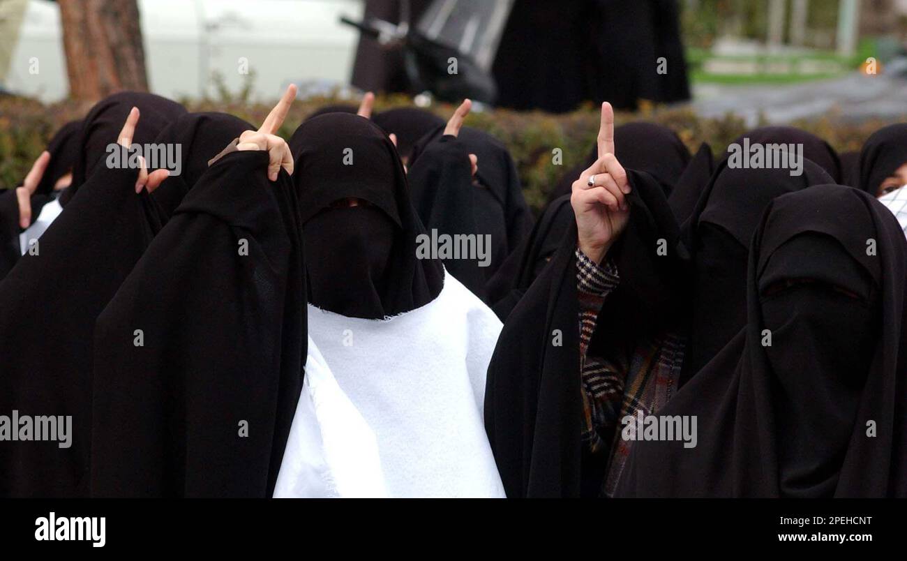 Covering their faces, Iranian women, who are members of a suicide