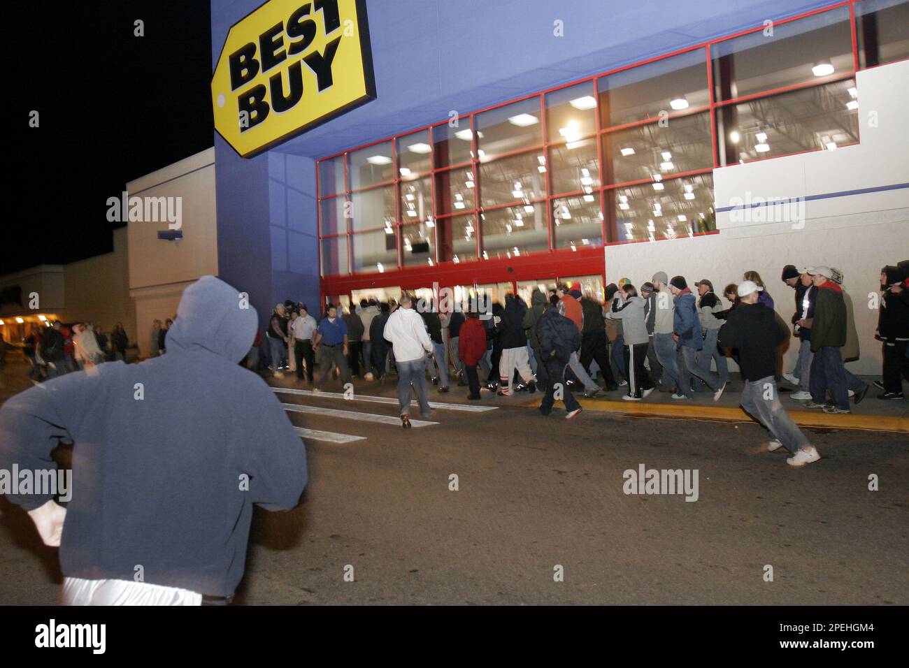 Shoppers storm the front doors of Best Buy as they open early 