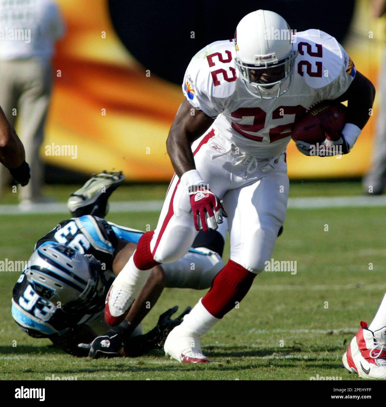 Arizona Cardinals' Emmitt Smith (22) slips the tackle of Carolina Panthers'  Michael Rucker (93) during the second quarter of the Panthers' 35-10 win in  Charlotte, N.C., Sunday Nov. 21, 2004. Smith was