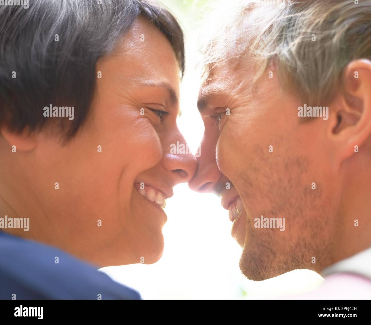 So in love...Side view of a couple staring lovingly into each others eyes. Stock Photo